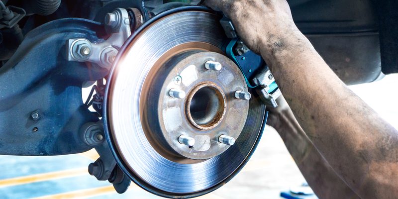 Close up car disk brake pad replacement service